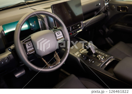 Closeup of a modern car steering wheel with control buttons for technology and convenience Closeup of a modern car steering wheel with control buttons for technology and convenience 126461822