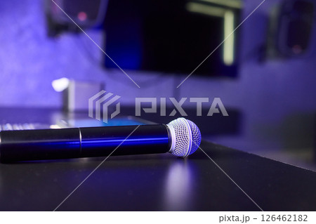 There are several colorful microphones beautifully arranged on a table in a trendy karaoke room There are several colorful microphones beautifully arranged on a table in a trendy karaoke room 126462182