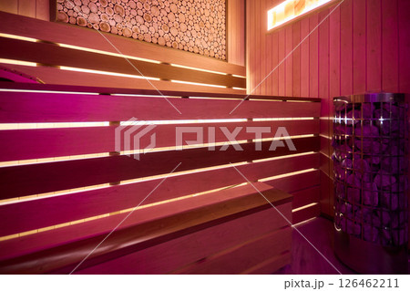 Experience the Cozy Wooden Sauna Interior Equipped with Inviting Warm Lighting and Ambiance Experience the Cozy Wooden Sauna Interior Equipped with Inviting Warm Lighting and Ambiance 126462211