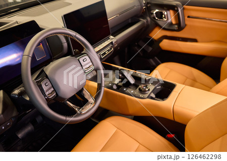 Closeup of a modern car steering wheel with control buttons for technology and convenience Closeup of a modern car steering wheel with control buttons for technology and convenience 126462298