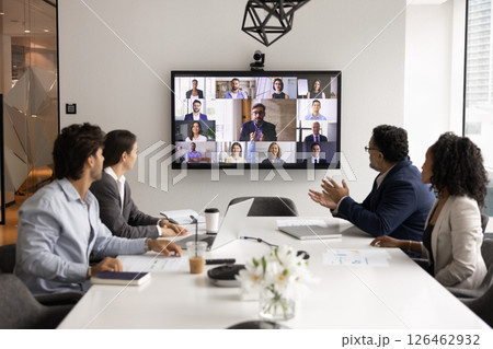 Businesspeople listening speech of boss displayed on screen during videocall 126462932