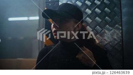 Action Movie Scene: Female Police Officer Hiding Behind the Wall, Holding a Gun Action Movie Scene: Female Police Officer Hiding Behind the Wall, Holding a Gun 126463639