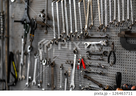 Various wrenches and hand tools hanging on 126463711