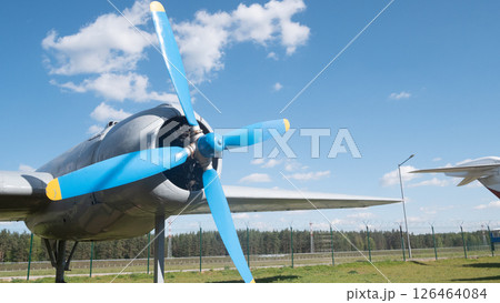 An iconic Soviet-era aircraft stands prominently with a striking blue propeller at an open air museum in Russia, highlighting the technological achievements of the past. 126464084