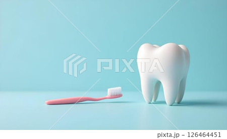 A toothbrush and a tooth placed on a blue surface, symbolizing dental care and oral hygiene 126464451