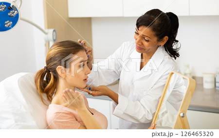 Woman having consultation at aesthetic medicine clinic Woman having consultation at aesthetic medicine clinic 126465320