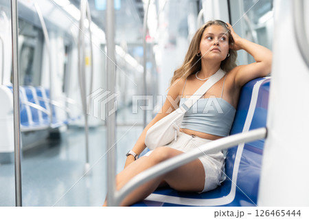 Young woman sitting in metro car Young woman sitting in metro car 126465444