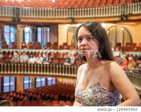 Portrait of young woman sitting in theatre salon Portrait of young woman sitting in theatre salon 126465482