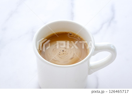 エスプレッソと牛乳を混ぜたコーヒー、カフェ・ラッテを飲みながらリラックスしているイメージ 126465717