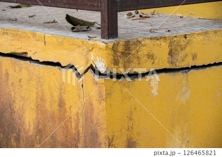 Cropped shot view of cracked building. Wider cracks often represent serious structural damage and can cause serious issues. Cropped shot view of cracked building. Wider cracks often represent serious structural damage and can cause serious issues. 126465821