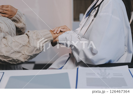 Medicine doctor hand reassuring her female patient 126467364