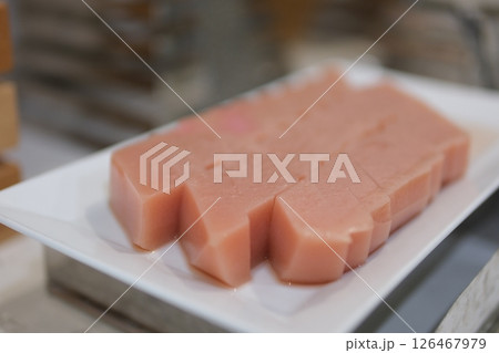 No baked raspberry cheesecake or raspberry cream mousse cake with jelly and fresh berries on top on a white plate on a gray concrete background. Summer cake No baked raspberry cheesecake or raspberry cream mousse cake with jelly and fresh berries on top on a white plate on a gray concrete background. Summer cake 126467979