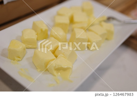 Pieces of fresh butter on white textured table, closeup. Space for text Pieces of fresh butter on white textured table, closeup. Space for text 126467983