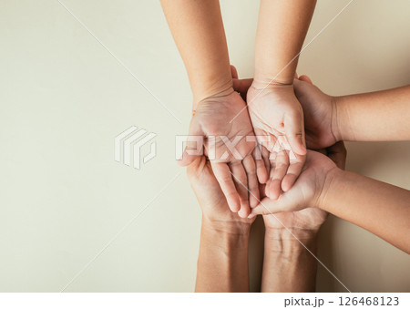 Celebrating Family Day, Parents and kid hold empty hands top view isolated. Embracing togetherness support and the continuity of family heritage. Celebrating Family Day, Parents and kid hold empty hands top view isolated. Embracing togetherness support and the continuity of family heritage. 126468123