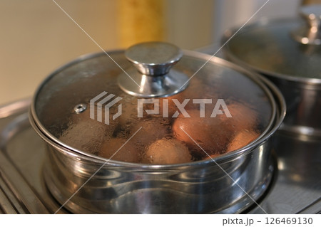buffet boiled eggs white plate filled with freshly boiled eggs, placed on a breakfast buffet, creating a clean and appetizing visual 126469130