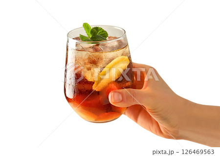 Hand holds a chilled iced tea drink with lemon and mint, isolated on white Hand holds a chilled iced tea drink with lemon and mint, isolated on white 126469563