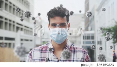 Image of virus cells over biracial man wearing face mask 126469823
