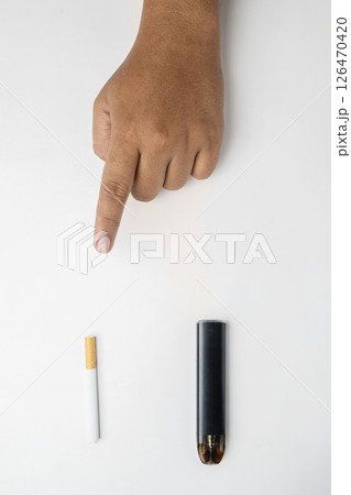 Human hand choose a cigarette, rolled tobacco in paper with a filter tube, or a vape or electronic cigarette are isolated on a white background. No or quit smoking, a bad habit, and unhealthy 126470420