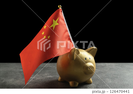 Piggybank with a China flag on a black background. Concept of economy, financial or government Piggybank with a China flag on a black background. Concept of economy, financial or government 126470441