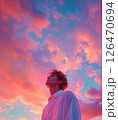 男性の横顔と夕焼けの空の背景　AI生成素材 126470694