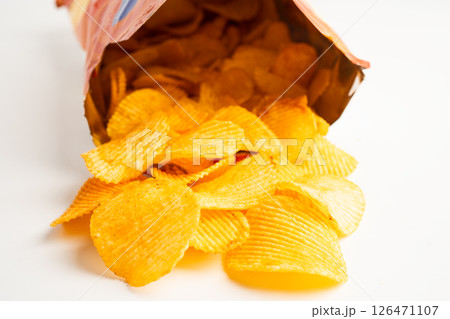 Potato chips, delicious BBQ seasoning spicy for crips, thin slice deep fried snack fast food in open bag. 126471107
