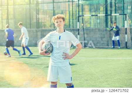 Junior football player on field Junior football player on field 126471702