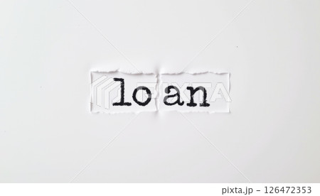 Loan text on torn paper against a plain background. 126472353
