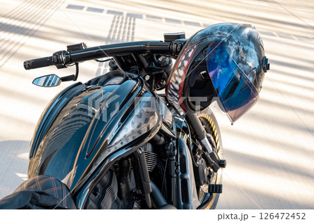 Cool motorbike with helmet on handle of motorcycle the city 126472452