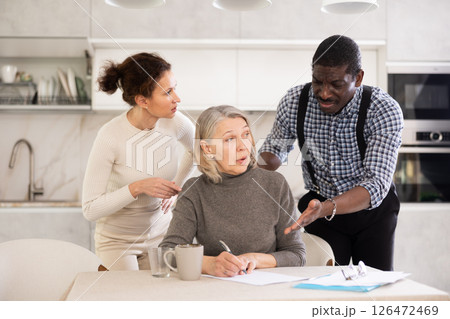 Mature woman relatives tell her who to include in her testament 126472469