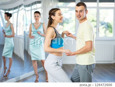 Couple in comfortable sports clothes waltz dancing during individual lesson 126472600