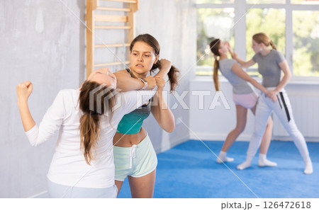 Females practicing self defence moves 126472618