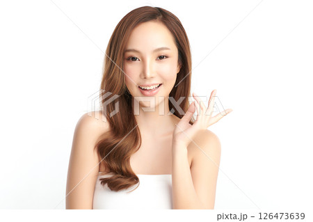 A beautiful young Asian woman with clean, fresh skin against a white background. Skincare, facial treatment, cosmetology, beauty, and spa. An elegant portrait of an Asian woman. A beautiful young Asian woman with clean, fresh skin against a white background. Skincare, facial treatment, cosmetology, beauty, and spa. An elegant portrait of an Asian woman. 126473639