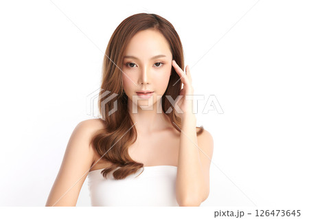 A beautiful young Asian woman with clean, fresh skin against a white background. Skincare, facial treatment, cosmetology, beauty, and spa. An elegant portrait of an Asian woman. 126473645