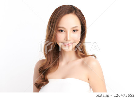 A beautiful young Asian woman with clean, fresh skin against a white background. Skincare, facial treatment, cosmetology, beauty, and spa. An elegant portrait of an Asian woman. 126473652