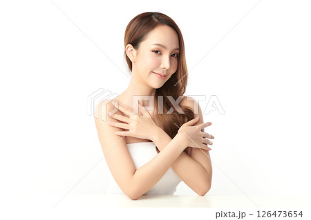 A beautiful young Asian woman with clean, fresh skin against a white background. Skincare, facial treatment, cosmetology, beauty, and spa. An elegant portrait of an Asian woman. 126473654