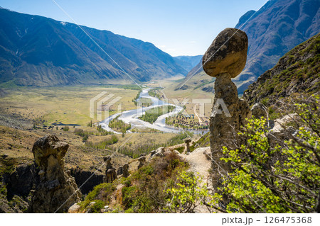 View of Chulyshman valley and river through stone mushrooms in Altai Russia Unique natural landscape with rock formations and flowing water View of Chulyshman valley and river through stone mushrooms in Altai Russia Unique natural landscape with rock formations and flowing water 126475368