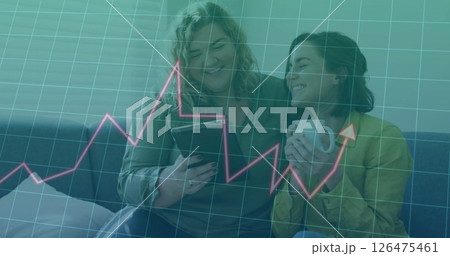 Image of data processing and diagrams over caucasian female couple using tablet at home 126475461