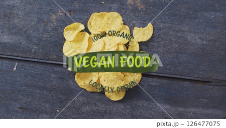 Potato chips on wooden surface with 100 percent Organic Vegan Food Locally Grown image 126477075