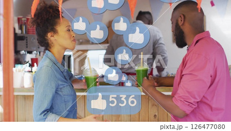 Social media likes image over people drinking green smoothies at counter Social media likes image over people drinking green smoothies at counter 126477080