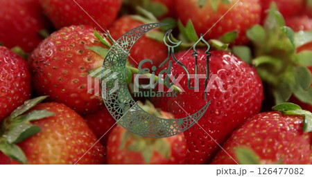 Eid Mubarak text image over close-up of fresh strawberries 126477082