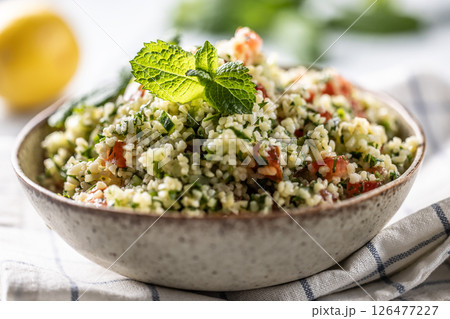 Traditional Tabouleh salad with bulgur, parsley, cucumber, tomato, coriander, garlic, mint and other ingredients 126477227