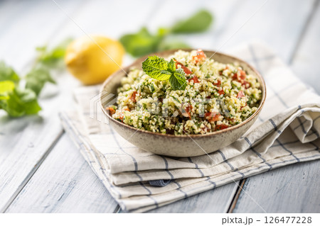 Traditional Tabouleh salad with bulgur, parsley, cucumber, tomato, coriander, garlic, mint and other ingredients Traditional Tabouleh salad with bulgur, parsley, cucumber, tomato, coriander, garlic, mint and other ingredients 126477228