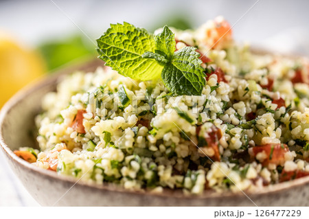 Traditional Tabouleh salad with bulgur, parsley, cucumber, tomato, coriander, garlic, mint and other ingredients 126477229