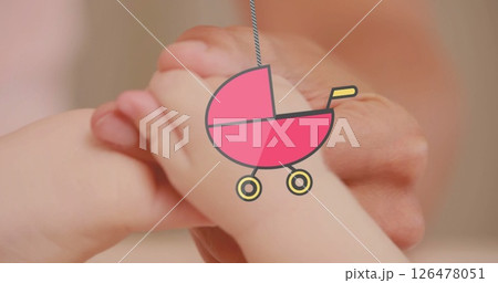 Image of hanging baby stroller over caucasian baby playing Image of hanging baby stroller over caucasian baby playing 126478051