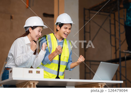 Team architects workers, men and women,  join success. 126479094