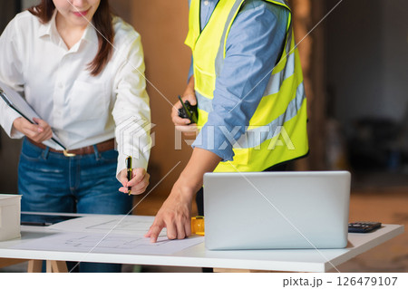 Engineer teams meeting working together wear worker helmets hardhat on construction site. Asian industry professional team. Engineer teams meeting working together wear worker helmets hardhat on construction site. Asian industry professional team. 126479107