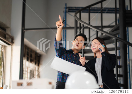 Engineer teams meeting working together wear worker helmets hardhat on construction site. Asian industry professional team. Engineer teams meeting working together wear worker helmets hardhat on construction site. Asian industry professional team. 126479112