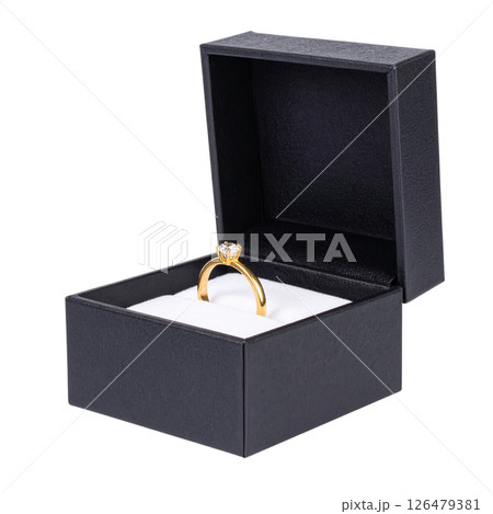 Open wooden gift box with a gold engagement ring Open wooden gift box with a gold engagement ring 126479381