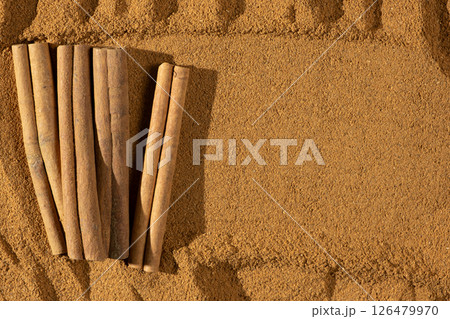Fine Ground Cinnamon with Cinnamon Sticks. Natural Cooking Spice Fine Ground Cinnamon with Cinnamon Sticks. Natural Cooking Spice 126479970