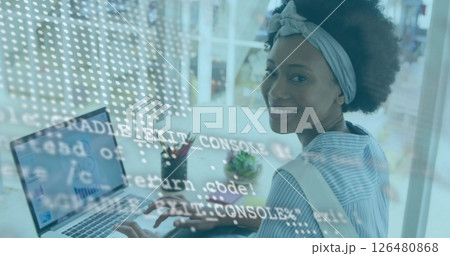 Image of financial data processing over african american businesswoman using laptop Image of financial data processing over african american businesswoman using laptop 126480868
